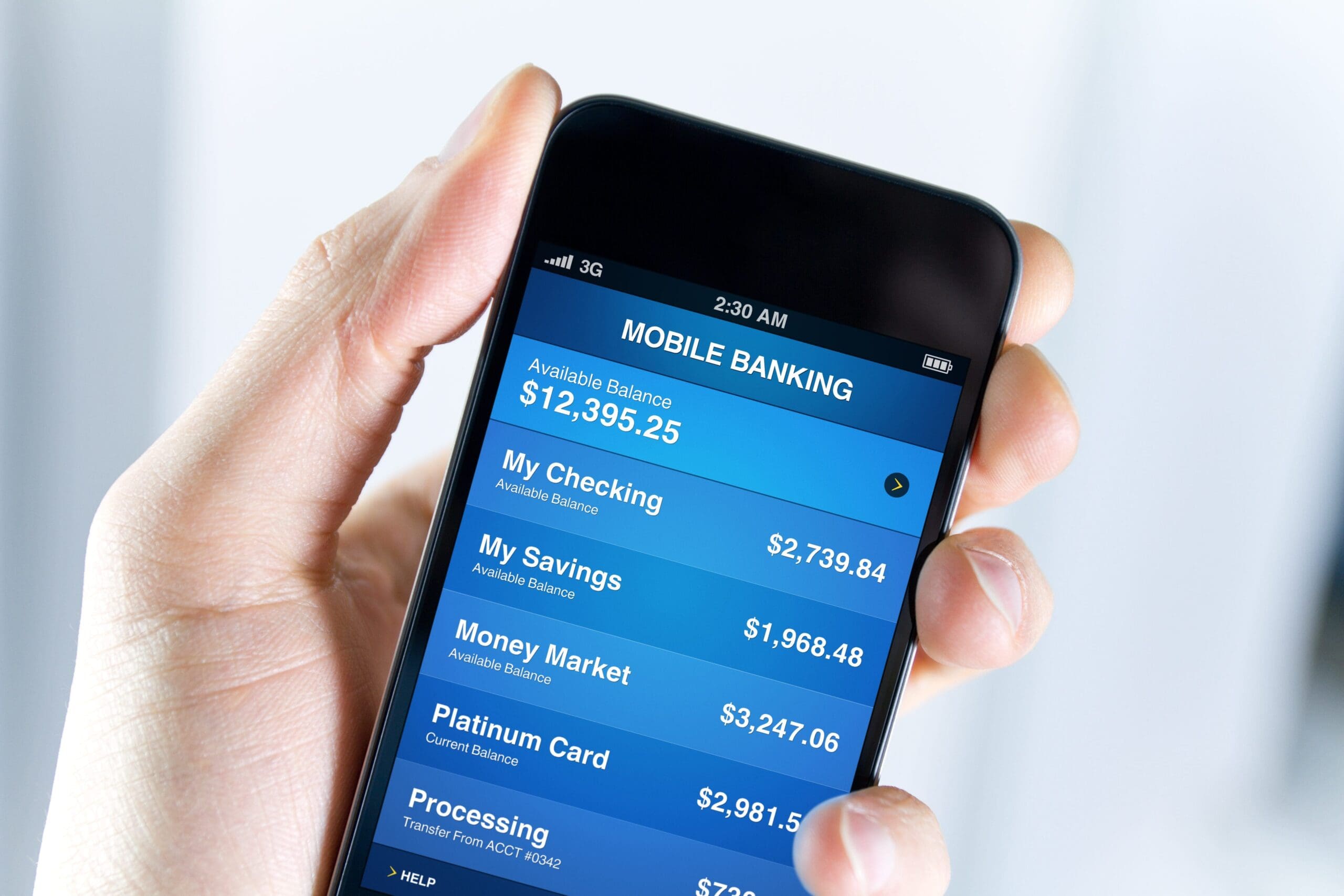 Person using mobile banking app on smartphone showing account balances